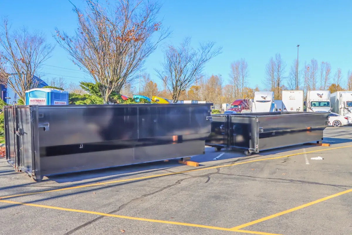 Professional dumpster rental service with roll-off container on residential driveway in Farmington Hills